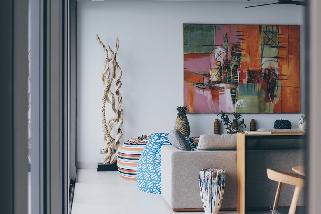 a living room with a painting on the wall