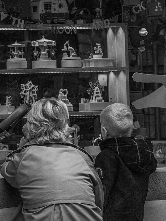 a couple of people looking at a display of figurines