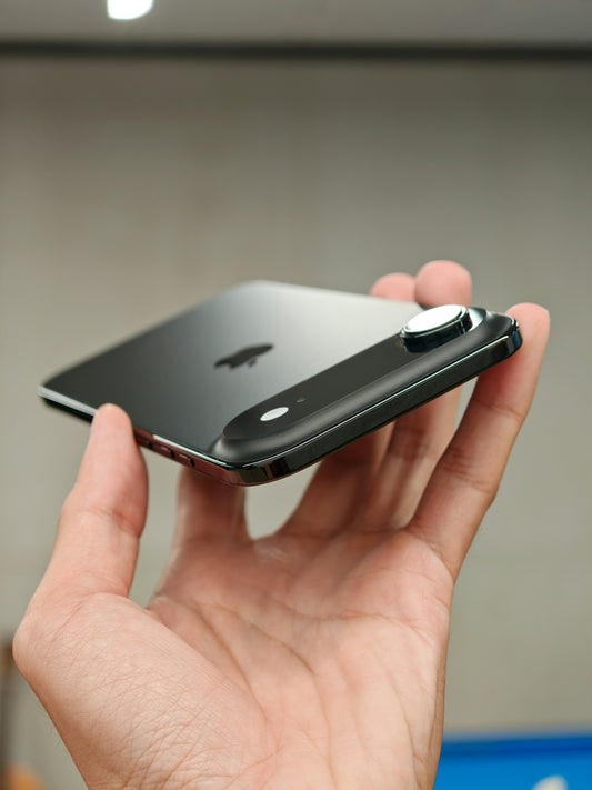 Hand holding a smartphone with a camera attachment.