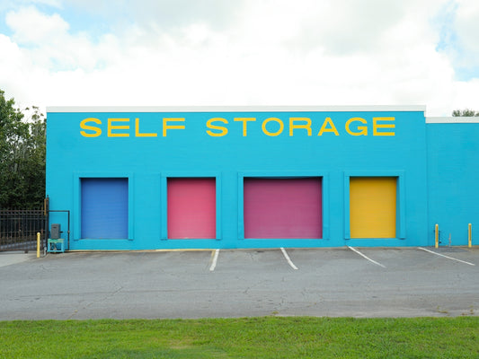 Brightly colored self storage building with four doors