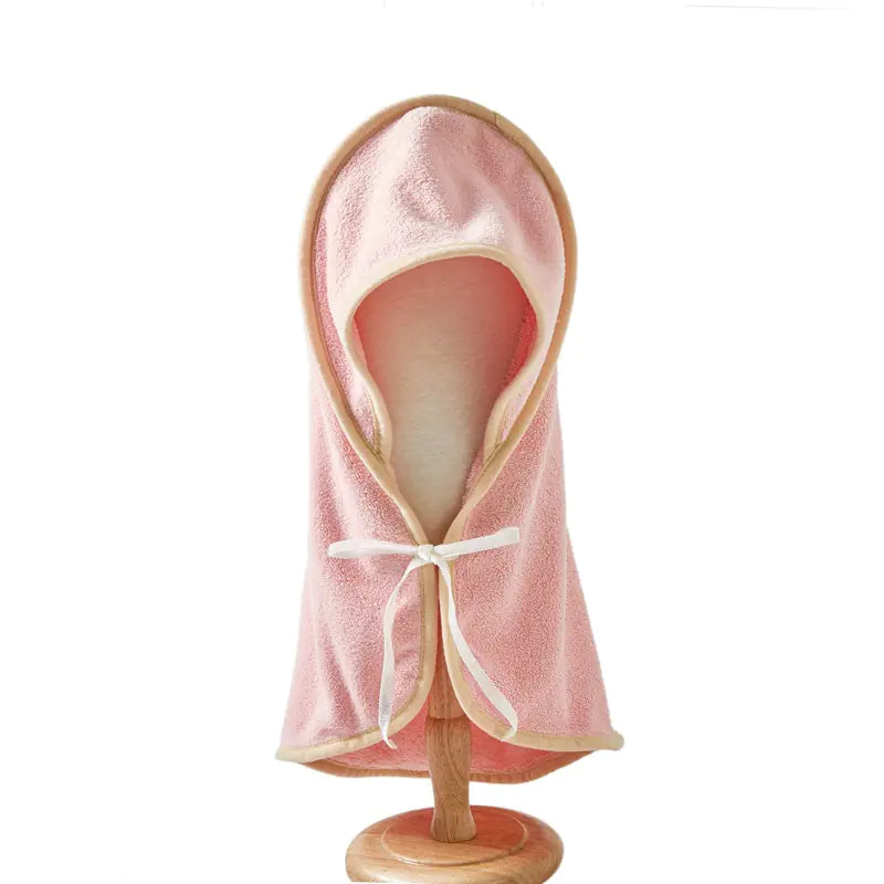 Soft, pink microfiber pet bathrobe with a cozy hood on a wooden stand
