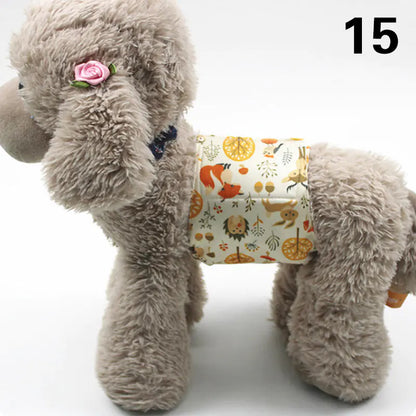 Fluffy gray plush dog toy with a pink flower on its head, wearing a patterned fabric diaper or pad on its lower body.