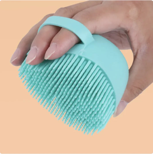 Mint-colored silicone dog bath brush with soft bristles for gentle pet grooming