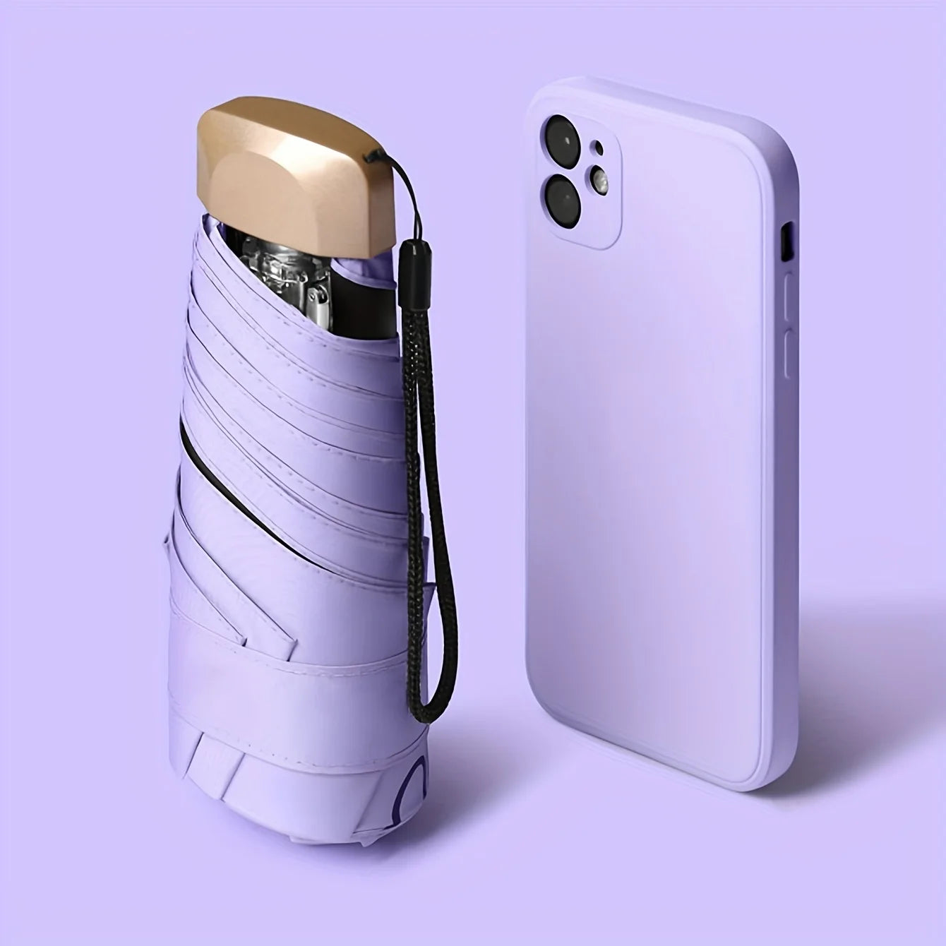 Compact folding sun umbrella with ultraviolet protection, alongside a sleek white smartphone on vibrant purple background.