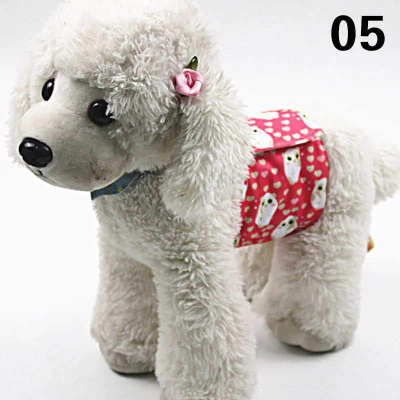 Fluffy grey dog toy with a red polka dot bandana around its neck, resting on a plain background.