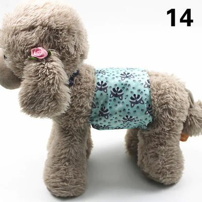 Fluffy gray dog plush toy with a pink flower accessory and a patterned turquoise diaper or pad on its body, positioned on a white background.
