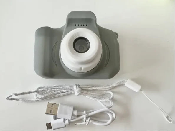 Compact kids' camera with camera lens, USB charging cable, and wrist strap - perfect for capturing memories from a child's perspective.